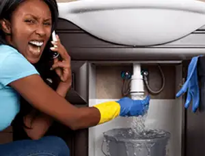 Emergency plumbing repair for a leaking sink drain under a bathroom vanity in Glendale, AZ