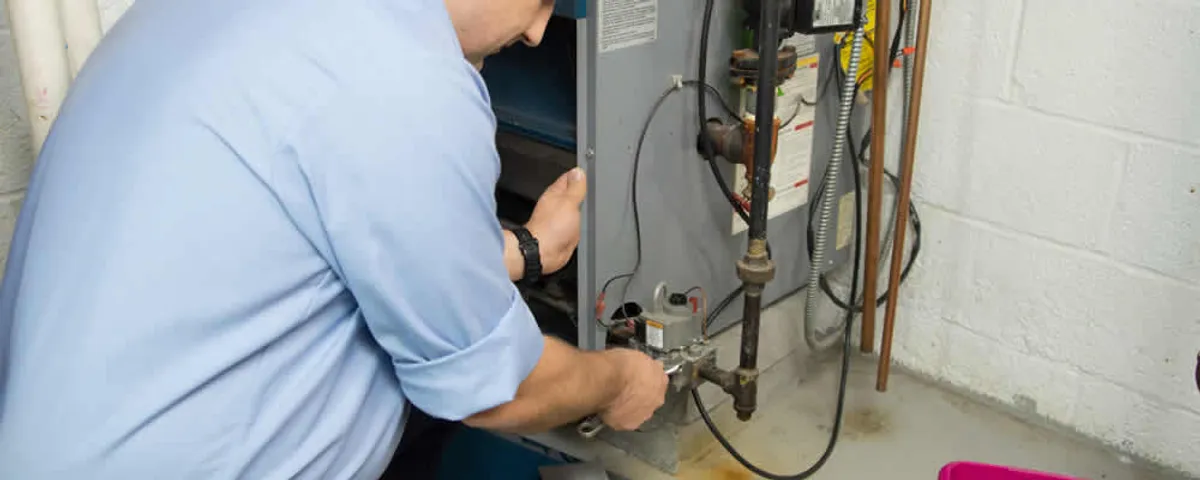 Furnace repair technician inspecting and servicing a home heating system in Glendale, AZ