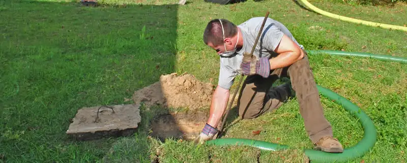 Septic pumping technician servicing a residential septic tank in Glendale, AZ